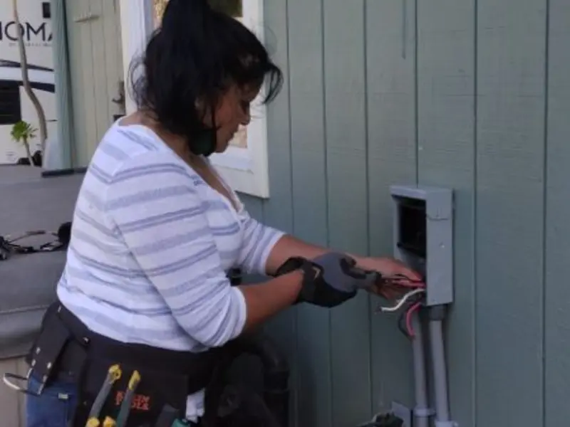 Licensed electrician wiring an exterior subpanel in Arnold